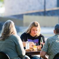 Family eating at table on Kirkhof Lawn.
